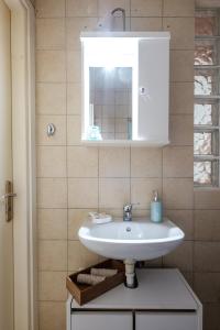 a bathroom with a white sink and a mirror at Pepe home in Nafplio