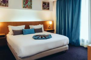 Un ou plusieurs lits dans un hébergement de l'établissement ONOMO Hotel Rabat Terminus