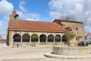 a large stone building with a statue in front of it at El Casino de Santa Cruz in Santa Cruz de la Sierra