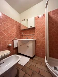 a bathroom with a tub and a sink and a shower at Biagetti Bedrooms Affittacamere in Santa Maria degli Angeli +5 photos