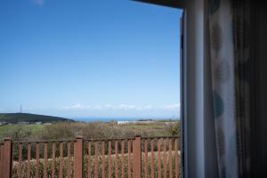 a view of the ocean from a window at 4 Meadow View in Woolacombe +20 photos