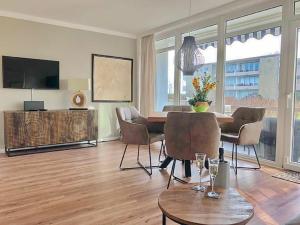 a living room with a table and chairs at Haus Baltic Whg 40 inkl WLAN in Grömitz