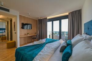 a bedroom with a large bed with a large window at Villa Luna-Private Heated Pool and sauna in Novalja