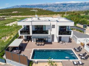 an aerial view of a house with a swimming pool at Villa Luna-Private Heated Pool and sauna in Novalja