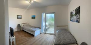 a bedroom with a bed and a tv and a window at Traumhaus am Wald 1 in Weiersbach