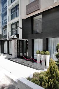 a building with a hotel sign on the side of it at Nova City Garni Hotel Signature Collection in Belgrade