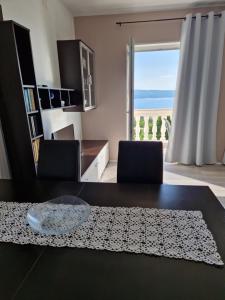 a dining room with a table and a view of the ocean at Apartments Velic in Crikvenica