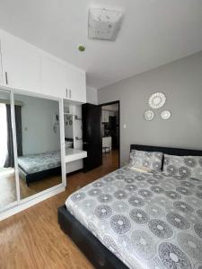 a bedroom with a large bed in a room at Mesaverte Residences T2-8H in Cagayan de Oro