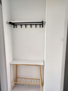 a closet with a white table and a shelf at M Apartments Piikahaka in Tampere
