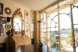 a room with a table and a large window at Ai Leoni Ruggenti Dimora della Storia e del Relax in Monferrato in Ottiglio