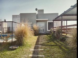 a house with tall grass in front of it at El Remanso in San José