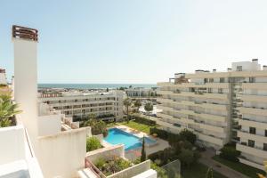 a view from the balcony of a building with a swimming pool at Marina Vilamoura Triplex in Vilamoura