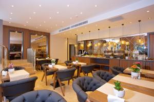 a restaurant with tables and chairs and a counter at Çanakkale Bosphorus Port Aspen Hotel in Çanakkale