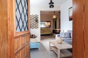 a room with a door and a living room with a couch at Pepe home in Nafplio