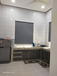 a kitchen with a large projection screen on the wall at MAA HOMESTAY BATU BURUK in Kuala Terengganu