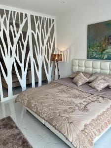 a bedroom with a bed with a white headboard at Modern studio in the heart of Amman in Amman