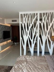 a bedroom with a bed and a white fence at Modern studio in the heart of Amman in Amman