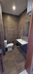 a bathroom with a toilet and a tub and a sink at VBH APARTMENT PACEVILLE ST. JULIAN'S in Paceville