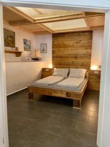 a bedroom with a bed with a wooden wall at Pferdestall - a87338 in Kiel