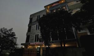 a tall building with lights on the side of it at Townhouse 22956 Hotel Grand Residency in Greater Noida