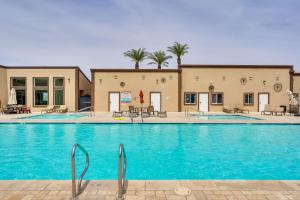 a pool at a hotel with blue water at Bullhead City Vacation Rental with Resort Pool! in Bullhead City
