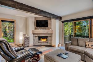 a living room with a couch and a fireplace at Interlude Condominiums 2-Bedroom Unit 101 in Snowmass Village