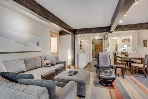 a living room with a couch and a table at Interlude Condominiums 2-Bedroom Unit 101 in Snowmass Village