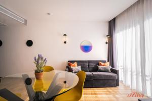 a living room with a glass table and a couch at Spinola Stays in St. Julianʼs