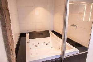 a bath tub in a bathroom with a shower at Wine Residence in Garibaldi