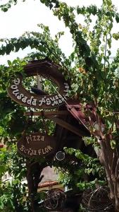 a sign that is sitting in a tree at Pousada Aguas Marinhas in Cabo de Santo Agostinho