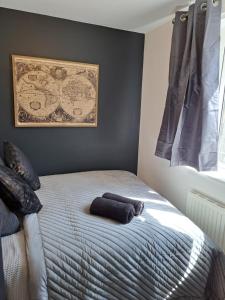 a bedroom with a bed with two pillows on it at Manse Apartment in Great Malvern