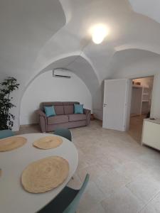 a living room with two tables and a couch at La Mia Corte in Tuglie