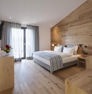 a bedroom with a large bed with a wooden wall at Hotel M120 in Munich