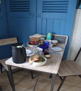 einen Holztisch mit Essen darüber in der Unterkunft L'ABRIGIT in Curcy-sur-Orne