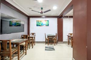 a dining room with wooden tables and chairs at City Star Hotel & Restaurant in Jawāharnagar