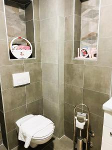 a bathroom with a toilet and a sink at Apartment River in Bratunac