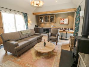 a living room with a couch and a table at Bolton in Appleby