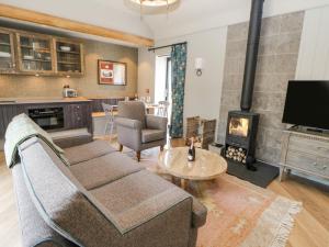 a living room with a couch and a fireplace at Bolton in Appleby