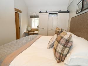 a bedroom with a bed with two pillows on it at Hilton in Appleby