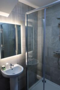 a bathroom with a sink and a shower at The Old Shop in Portree