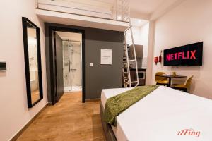 a bedroom with a bed and a table and a ladder at Spinola Stays in St. Julianʼs