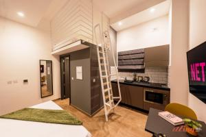 a small apartment with a loft bed in a kitchen at Spinola Stays St Julian's in St. Julianʼs