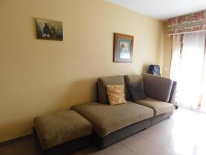 a couch in the corner of a living room at Apartamentos As Caldelas in O Grove