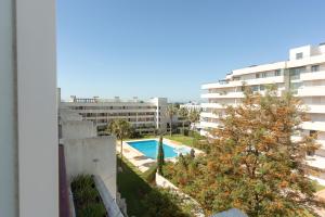 an apartment with a swimming pool in a building at Marina Vilamoura Relax Apartment in Vilamoura