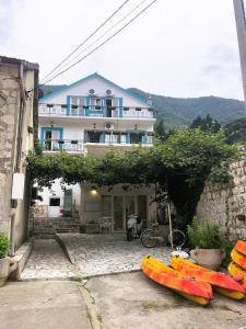 a house with two kayaks parked in front of it at Apartments Djurovic in Kotor +3 photos