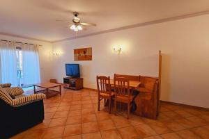 a living room with a table and a couch at Holiday Apartment T2 Private Residence in Tavira