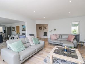 a living room with two couches and a table at Greystones in Gloucester