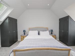 a bedroom with a large bed with black cabinets at Greystones in Gloucester