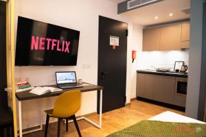 a kitchen with a desk with a laptop on it at Spinola Stays in St. Julianʼs
