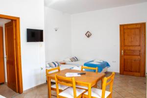 a room with a table and chairs and a bed at Alexandra's House in Skiathos